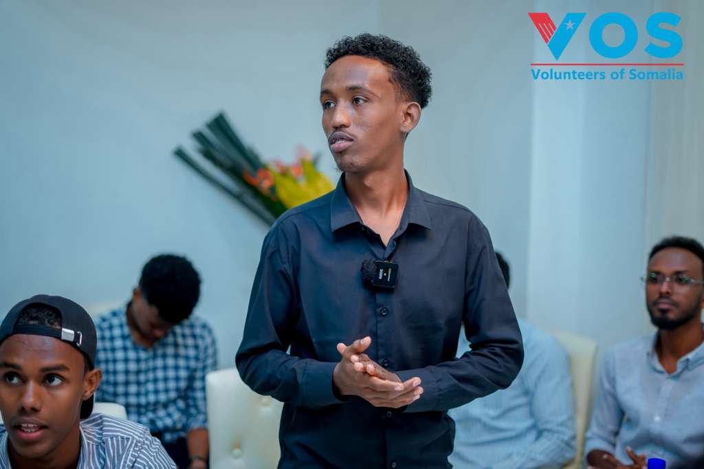 A young leader speaking with community members